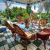 Hale Kawehi Bnb Guesthouse in Hilo patio dining area with wicker chairs and lush garden view