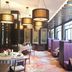 Chateau Star River Beijing restaurant interior with purple booths and hanging pendant lights in Beijing