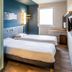ibis budget Pertuis Portes du Luberon room with two twin beds and window in Pertuis