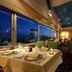 Hotel Nikko Tsukuba in Tsukuba dining room with city view at dusk and set tables