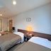 Hotel Sun Abashiri guest room with two single beds and simple seating in Abashiri