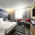 Novotel Marne la Vallée Noisy le Grand room with king bed, sofa, and window seating