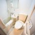 Super Hotel Inn Sendai Kokubuncho compact bathroom with toilet, sink, shower, and towel rack in Sendai