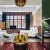 Stamba Hotel Tbilisi room with exposed brick, large windows, white bed and gold coffee table