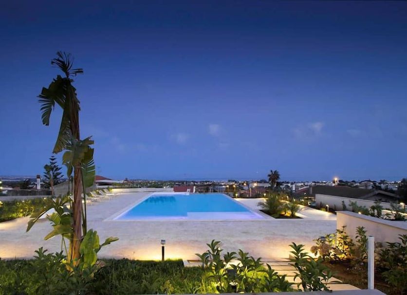 I Giardini della Castellana in Marina di Ragusa with a rooftop pool at dusk