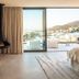 Sovn Experience+Lifestyle Cape Town room with fireplace, balcony, and mountain and sea views