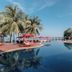 Khaolak Laguna Resort in Khao Lak with infinity pool, palm trees, and oceanfront loungers