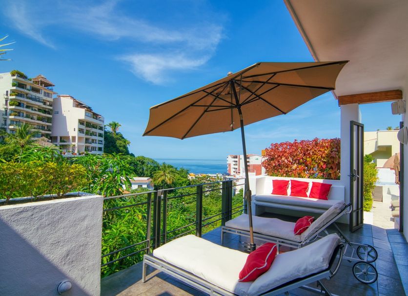 Casa Cupula Luxury Lgbt Boutique Hotel in Puerto Vallarta balcony with ocean view, lounge chairs and umbrella