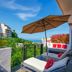 Casa Cupula Luxury Lgbt Boutique Hotel in Puerto Vallarta balcony with ocean view, lounge chairs and umbrella