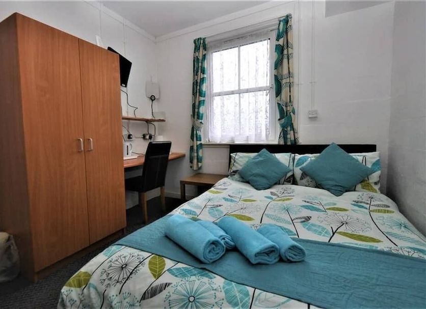 The Waterfront, Greenock bedroom with double bed, desk, wardrobe and window