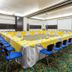 Sonesta Hotel Valledupar meeting room with U-shaped conference table and blue chairs in Valledupar