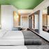 B&B Hotel Baden-Airpark room in Rheinmunster with twin beds, green ceiling and wall mural