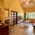 Hotel Villa Mercedes Palenque room with large window, tile floors, seating area and ceiling fan in Palenque