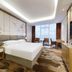 Fulai Garden Hotel in Shenzhen guest room with king bed, work desk, chairs, and large window