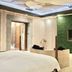 Ohya Chain Boutique Motel Taoyuan in Taoyuan City, a room with bed, wicker seating and green wall TV area