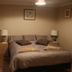 Westside Studio Apartments in Armidale bedroom with a double bed, bedside lamps, mirror, and basket storage