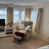 Hogwarts Bed and Continental Breakfast in Sheerness living room with TV, armchair, and bay windows