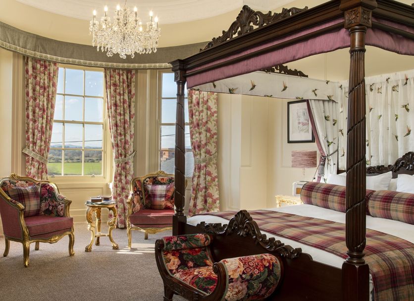 The Tudor House Hotel, Tewkesbury: ornate four-poster bedroom with countryside view and chandelier