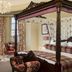 The Tudor House Hotel, Tewkesbury: ornate four-poster bedroom with countryside view and chandelier