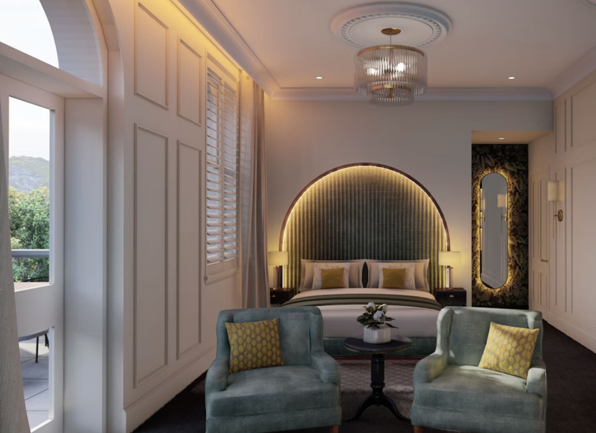 The Clements Hotel Cambridge suite with arched bed alcove, seating area and mirror