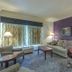 La Quinta Inn & Suites by Wyndham Loveland/Estes Park guest room with sofa, table, and window seating in Loveland