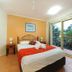 Beach Court Holiday Villas in Airlie Beach bedroom with balcony view and sliding glass doors