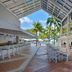 Melia Santiago De Cuba covered terrace with white seating and palm-lined pool view in Santiago de Cuba