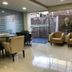 Tri Hotel Centro Chapecó lobby seating area with large windows and outdoor patio view in Chapecó