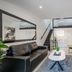 Caribbean Noosa living room in Noosa Heads with black leather sofa, TV, stairs and loft mezzanine
