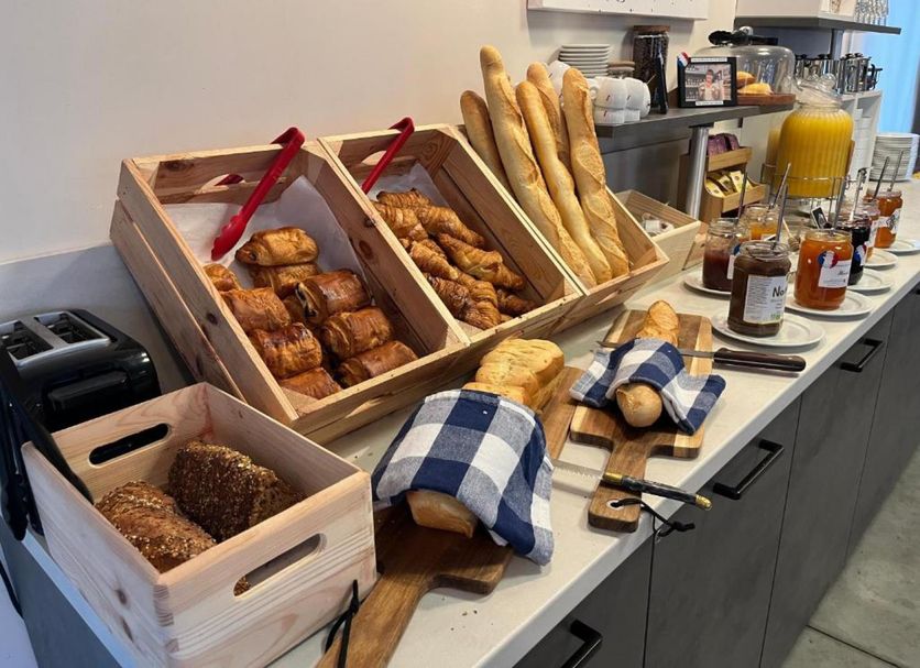 Hotel Caiman, Pierrelatte breakfast buffet with pastries, baguettes, jams and juice