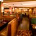 Premier Inn Northampton West - Harpole restaurant with wooden booths and warm ambient lighting