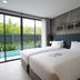 Kokotel Phuket Nai Yang Beach room with twin beds and sliding doors to a pool view in Phuket City