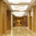 Fullon Hotel Hualien hallway in Hualien City with polished floors, wood paneling and pendant lights