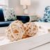 Ocean Eleven Suites in New Smyrna Beach lounge with navy sofa, patterned chair and wicker tray decor