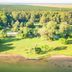 Puerto Valle Hotel De Esteros in Puerto Valle with lush lakeside grounds and forest views