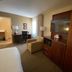 Comfort Inn Rutland - Killington room with desk, TV, armchair, and wardrobe in Rutland