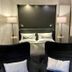 Country-Suites By Verdino Living - Apartments & Privatzimmer in Braunlage bedroom with two black chairs and a bed
