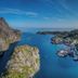 Nusfjord Village & Resort in Ramberg overlooking a fjord with mountains, a road, and coastal village