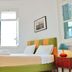 City Circus Athens guest room in Athens with green bed, open window and colorful bedside lamps