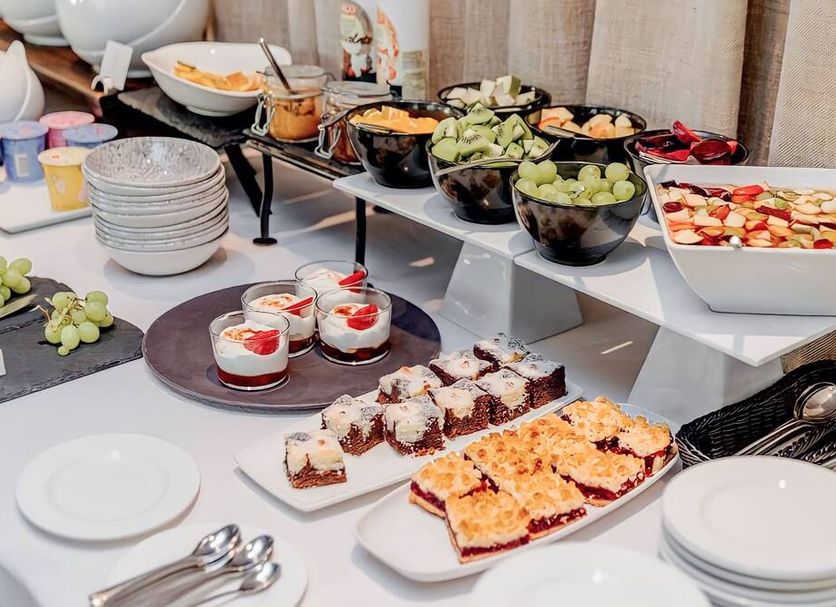 Savoy Boutique Hotel by TallinnHotels in Tallinn breakfast buffet with fruit, pastries, yogurt, and plates