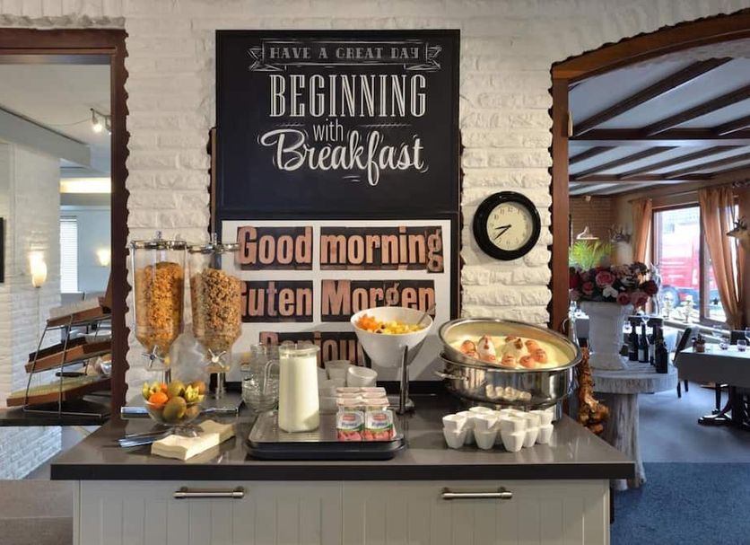 Hotel Schilberg in Slenaken breakfast buffet with cereal, fruit, juice and eggs on a counter