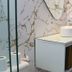 Pousada Chale Heloisa bathroom vanity with round sink and marble-look wall in Jijoca de Jericoacoara