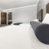 Hollywood Palms Inns & Suites guest room in Los Angeles with two beds, TV, mini fridge and open bathroom door
