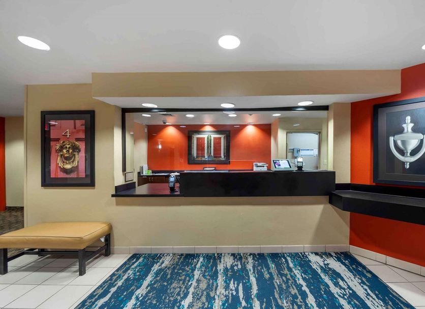 Extended Stay America Suites - Oklahoma City - Nw Expressway lobby check-in desk with orange walls and blue rug