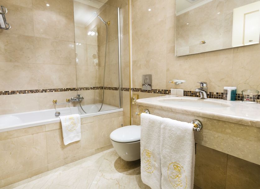 Luxury Family Hotel Royal Palace Prague bathroom with bathtub, shower, toilet and marble vanity