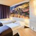 B&B Hotel Frankfurt City-Ost room with two single beds, window, and Frankfurt skyline wall art