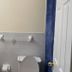 Nwk 457 Room 111-A bathroom in Newark with sink, toilet, and tiled shower area
