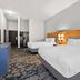 Baton Rouge Inn & Suites Lsu-Medical Corridor room in Baton Rouge with two white beds and TV