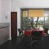 Bon Marie B&B in Hamilton dining area with table, chairs, TV, and balcony doors to greenery