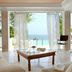 The Danai in Nikiti: sea-view villa lounge with floor-to-ceiling curtains and terrace overlooking the ocean